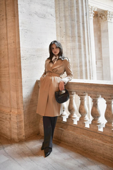 a lady in a wrap coat and a pair of black pants